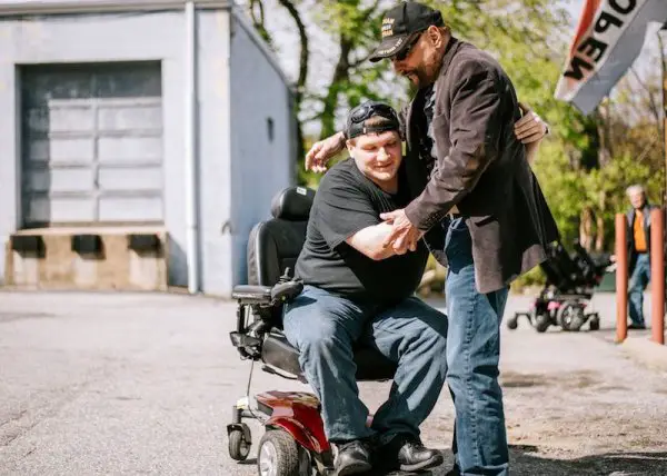 Phillip gives motorized wheelchair Courtesy of GoFundMe Heroes 1