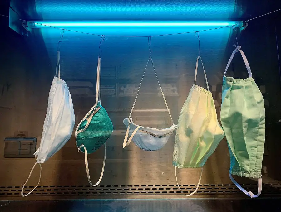 Surgical masks being decontaminated for reuse under ultraviolet light
