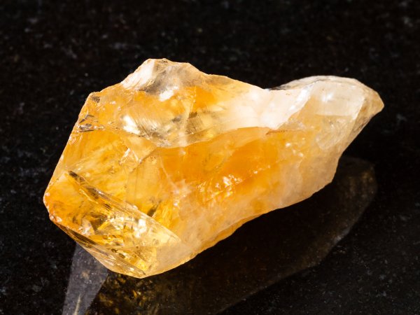 raw crystal of citrine gemstone on black 2021 08 26 23 03 36 utc