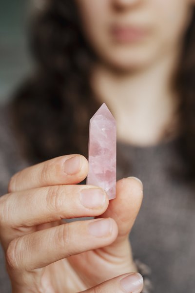 woman holding a rose quartz crystal 2022 12 16 01 27 16 utc