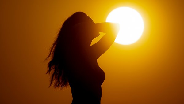 bikini beach woman silhouetted against golden sun 2023 11 27 05 05 59 utc